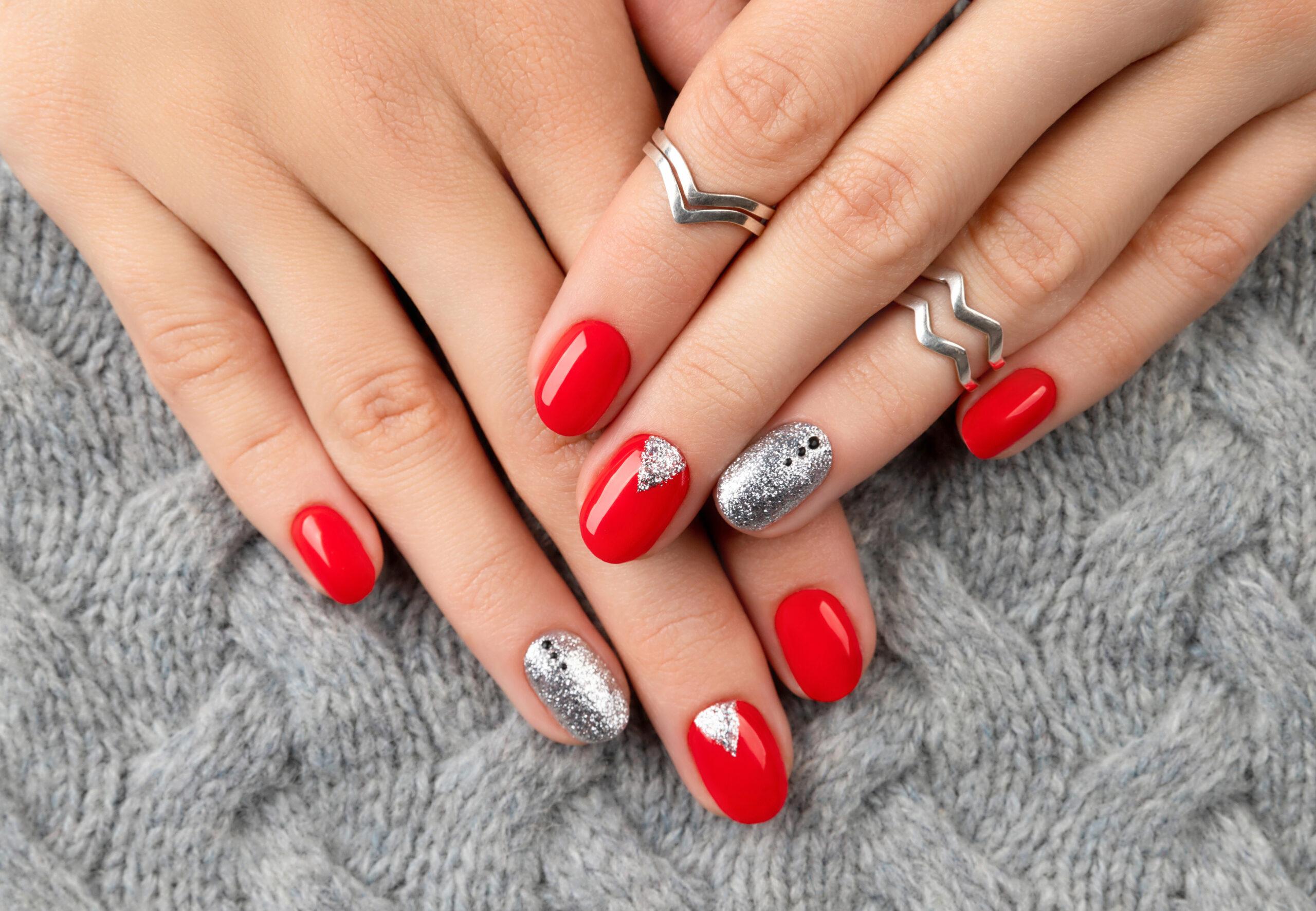 Woman's hands with fashionable red manicure. Christmas new year nail design. Manicure, pedicure beauty salon concept.